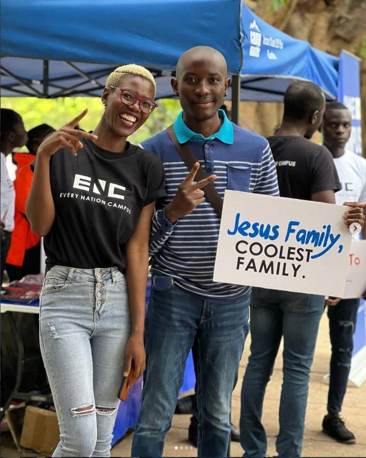 Church members holding a sign that reads Jesus Family, coolest family